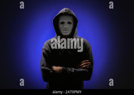 Professional hacker in mask on dark background Stock Photo