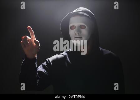 Professional hacker using virtual screen on dark background Stock Photo