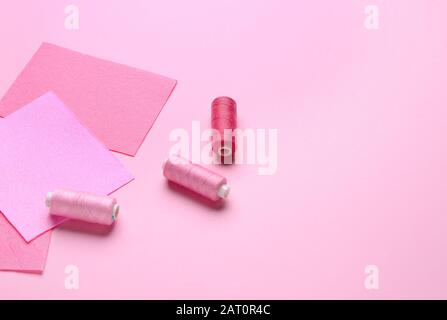 Sewing threads on color background Stock Photo