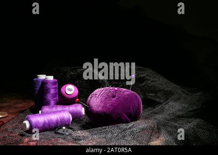Set of tailor's supplies on dark background Stock Photo
