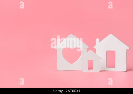 Different figures of houses on color background. Concept of buying real estate Stock Photo