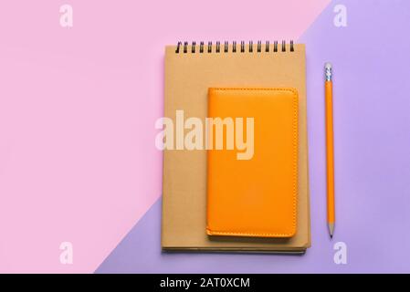 Stylish notebooks with pencil on color background Stock Photo