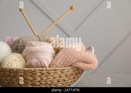 Basket with knitting yarns on table Stock Photo