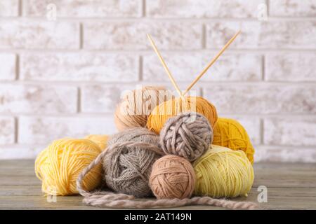 Knitting yarns with needles on table Stock Photo