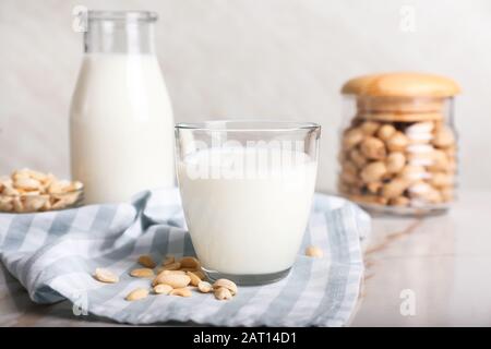 Glass of tasty peanut milk on white table Stock Photo