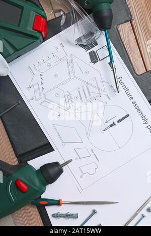 Furniture assembling plan with set of tools on table Stock Photo