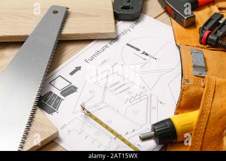 Furniture assembling plan with set of tools on table Stock Photo
