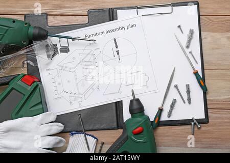 Furniture assembling plan with set of tools on table Stock Photo