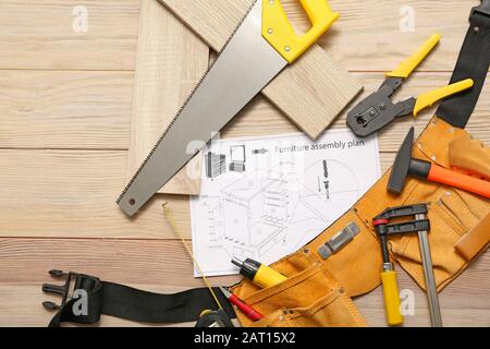 Furniture assembling plan with set of tools on table Stock Photo