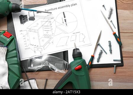 Furniture assembling plan with set of tools on table Stock Photo