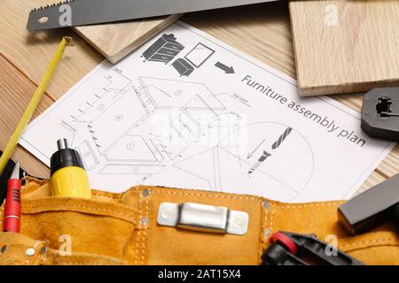 Furniture assembling plan with set of tools on table Stock Photo