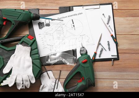 Furniture assembling plan with set of tools on table Stock Photo