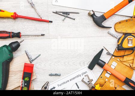 Furniture assembling plan with set of tools on table Stock Photo