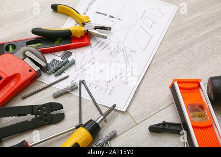 Furniture assembling plan with set of tools on table Stock Photo