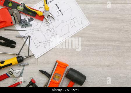 Furniture assembling plan with set of tools on table Stock Photo