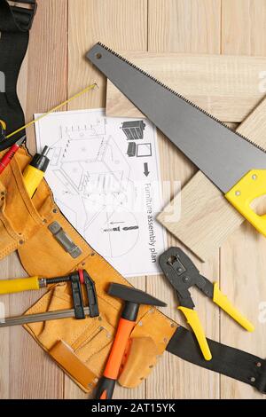 Furniture assembling plan with set of tools on table Stock Photo