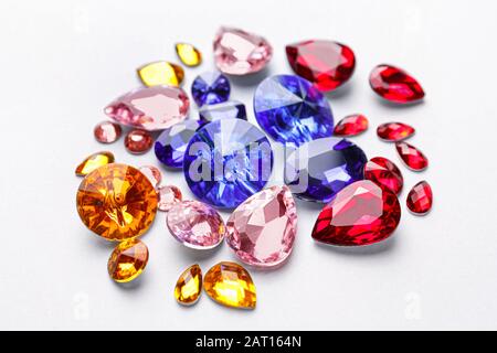 Different precious stones for jewellery on light background Stock Photo