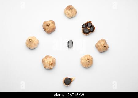 Black garlic on white background Stock Photo