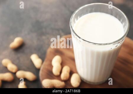 Glass of peanut milk on grey background, closeup Stock Photo
