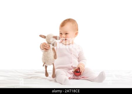 Cute little baby with Christmas ball and toy on white background Stock Photo