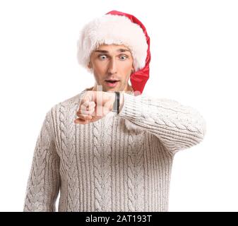 Surprised young man in Santa hat and with watch on white background. Christmas countdown concept Stock Photo