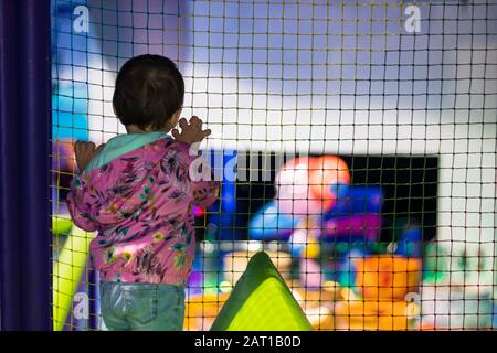 a cute little girl in an indoor playground in a shopping centre in Dubai, United Arab Emirates. Stock Photo