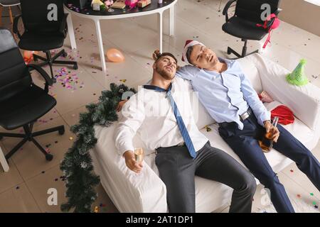 Drunk men sleeping after New Year party in office Stock Photo