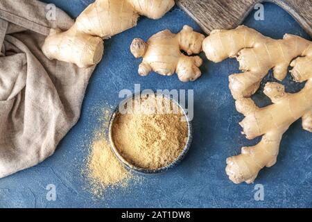 Fresh and ground ginger on dark background Stock Photo