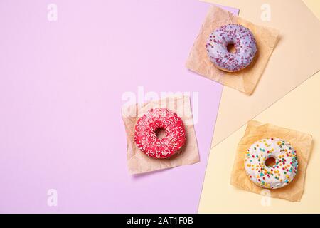 Sweet tasty donuts on color background Stock Photo