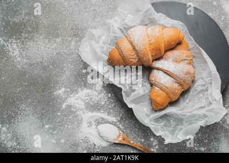 Tasty croissants on grey table Stock Photo