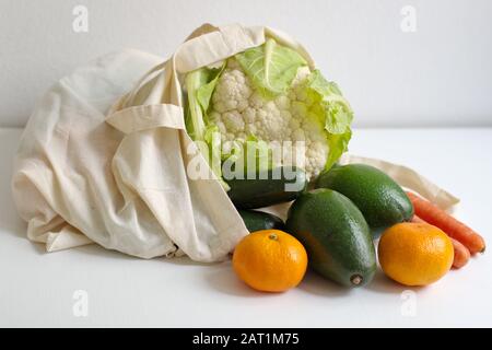 Healthy fresh vegetables on the white table in reusable bag Stock Photo