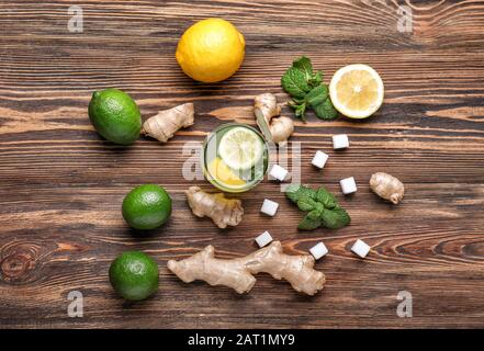 Composition with tasty ginger lemonade on wooden background Stock Photo