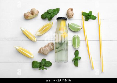 Composition with tasty ginger lemonade on white wooden background Stock Photo