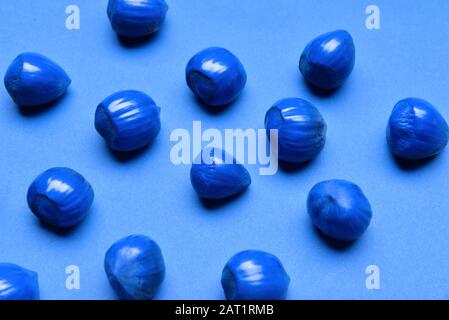 Blue hazelnuts on color background Stock Photo