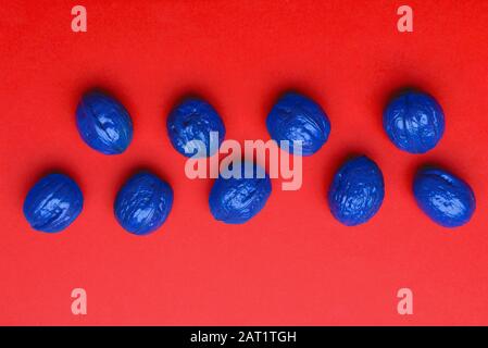 Blue painted walnuts on color background Stock Photo