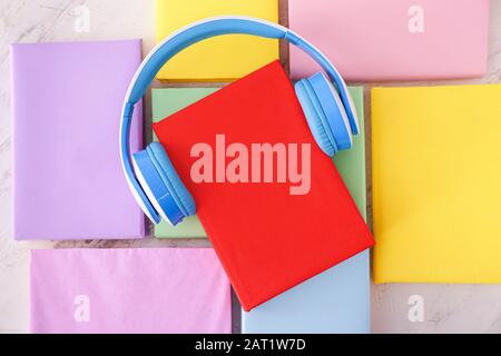 Books and modern headphones on table. Concept of audiobook Stock Photo