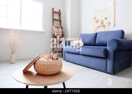 Box with sea shells on table in room Stock Photo