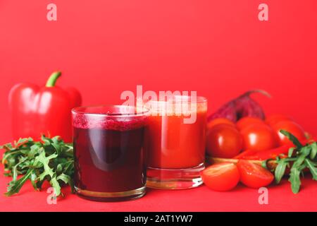 Glasses of fresh vegetable juices on color background Stock Photo