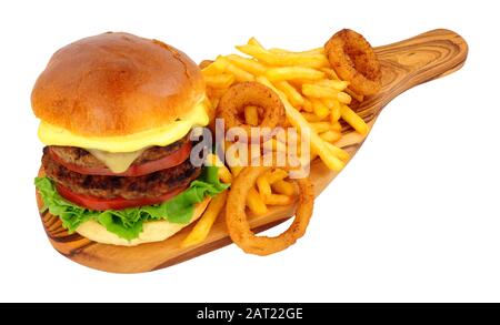 Cheese beef burger and French fries with battered onion rings on an olive wood serving board isolated on a white background Stock Photo
