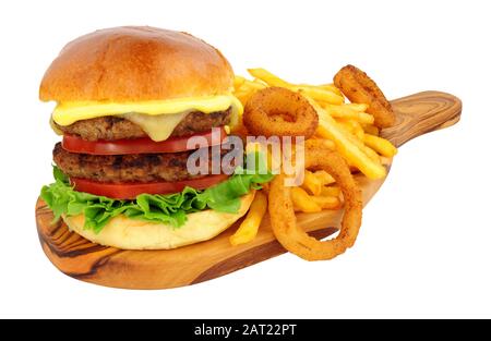 Cheese beef burger and French fries with battered onion rings on an olive wood serving board isolated on a white background Stock Photo
