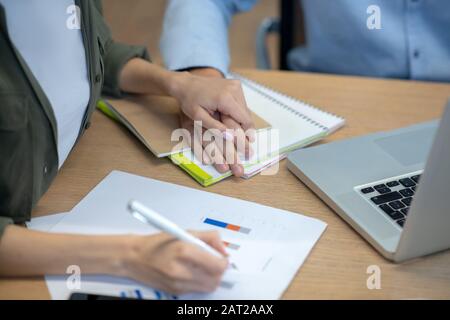 Close up picture of mans han tocuhing womans hand Stock Photo