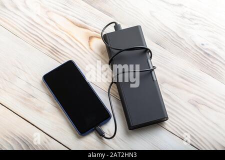 External aluminium battery for for mobile devices. Smart phone charger with USB cable. Top view of place for text. Stock Photo
