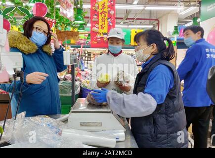 Beijing, China. 29th Jan, 2020. BEIJING, CHINA - JANUARY 29, 2020: A customer and employees of a supermarket. An outbreak of pneumonia-like disease caused by a coronavirus was registered in Wuhan, a port city of 11 mln people, the administrative center of the Hubei province, in the end of December 2019. Now over 7 thousand people are infected, the death toll is 170. Roman Balandin/TASS Credit: ITAR-TASS News Agency/Alamy Live News