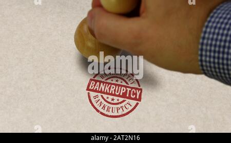 Bankruptcy stamp and stamping hand. Business crash, debt, finance, bankrupt, economy, recession and financial problem concept. Stock Photo