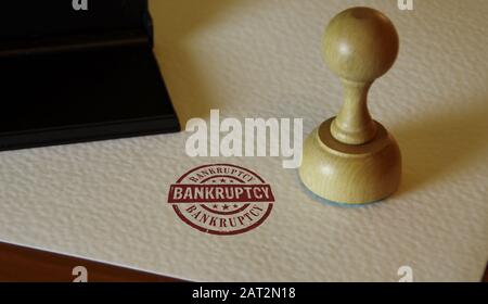 Bankruptcy stamp and stamping hand. Business crash, debt, finance, bankrupt, economy, recession and financial problem concept. Stock Photo