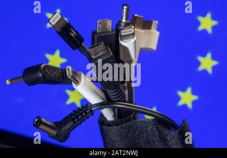 Schwerin, Germany. 29th Jan, 2020. Charging cables for different mobile phone models can be seen in front of an EU flag. According to its own statements, the EU Commission wants to make a new push for uniform loading equipment. Uniform charging cables should not only make life easier for consumers, but also reduce electronic waste. Credit: Jens Büttner/dpa-Zentralbild/dpa/Alamy Live News Stock Photo