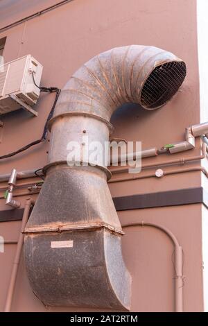 A close uo view of a large metal air vent attached to the side of a building Stock Photo
