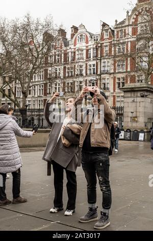 London / UK - Nov 28, 2019: asian tourists taking picture in front of the Brittish Museum in London.  It was the first public national museum in the w Stock Photo