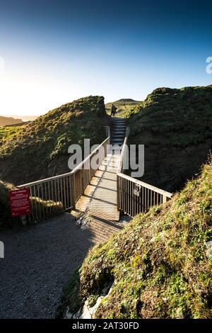 The footbridge linking the mainland and Porth Island Trevelgue Head in Newquay in Cornwall. Stock Photo