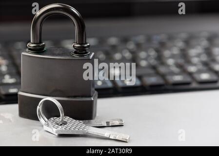 Computer security concept with a padlock on a keyboard Stock Photo